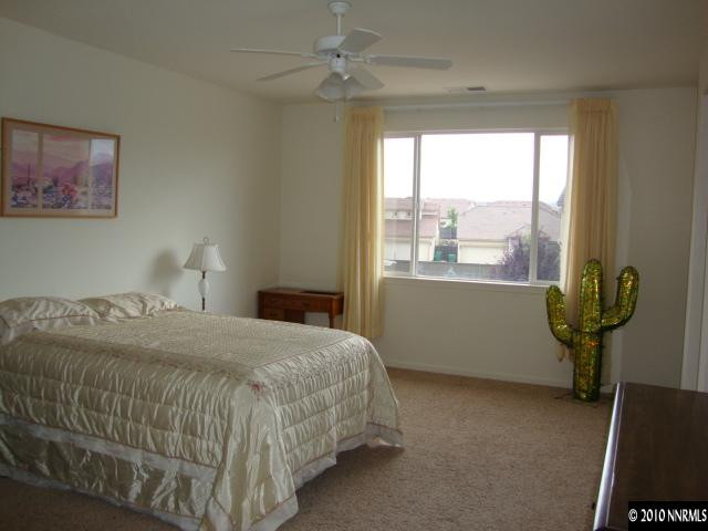 13765 Seabiscuit Drive Reno, NV 89521 - Photo 7 of 9 a bedroom with a bed and a window