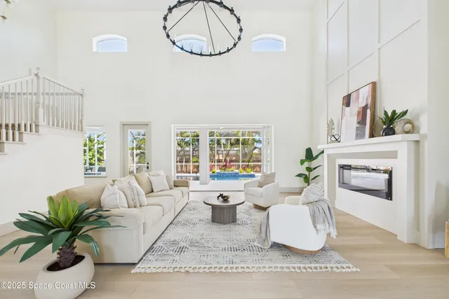 a living room with furniture and a potted plant