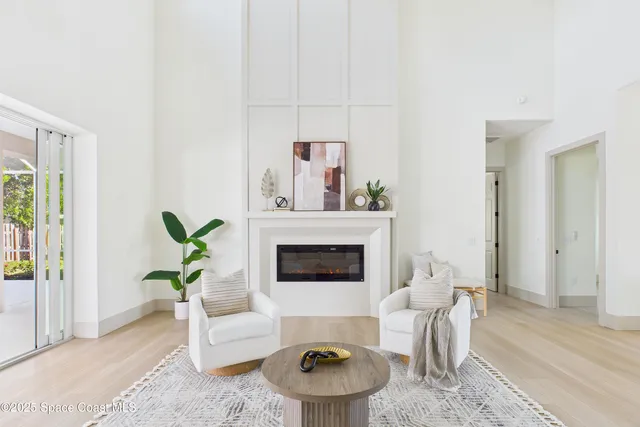 a kitchen with stainless steel appliances a table chairs and a refrigerator