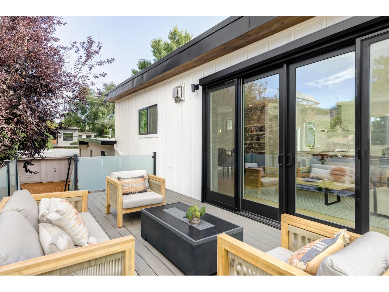 2895 18th Street Boulder, CO 80304 - Photo 26 of 29 Designed for year-round enjoyment, this outdoor retreat features a gas fireplace, a staircase to the backyard, and sweeping mountain vistas; perfect for hosting gatherings, savoring morning coffee, or unwinding under the stars.