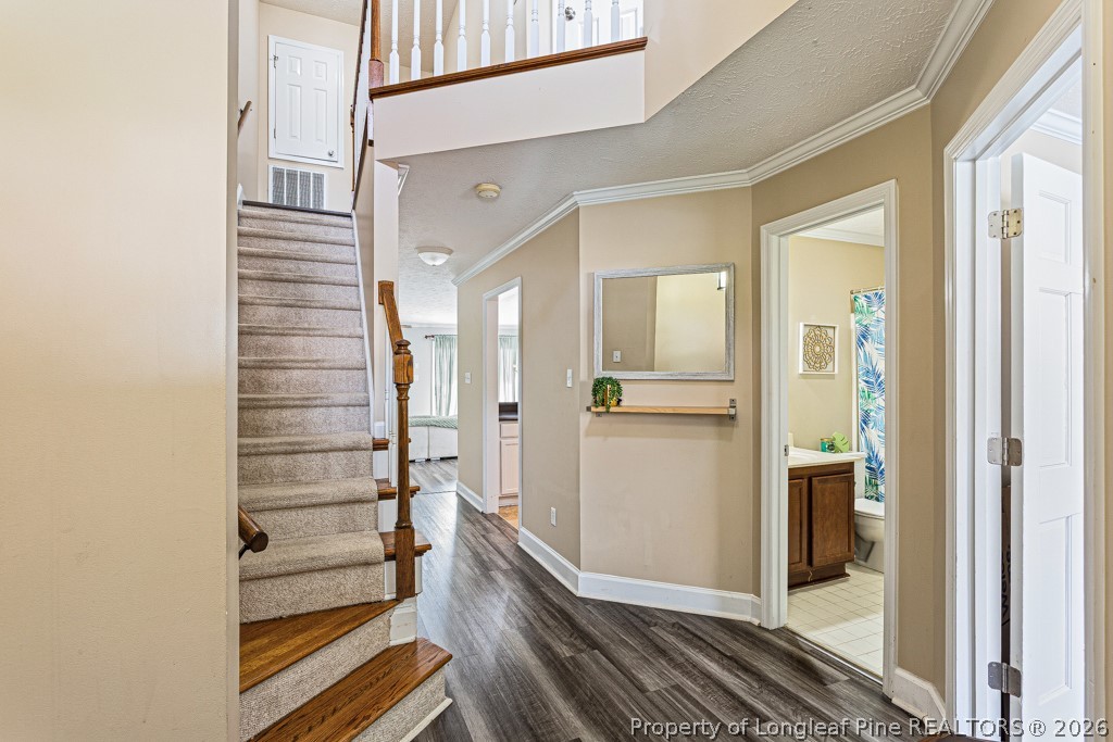 461 Lands End Road Fayetteville, NC 28314 - Photo 4 of 31 a view of a hallway with wooden floor and staircase