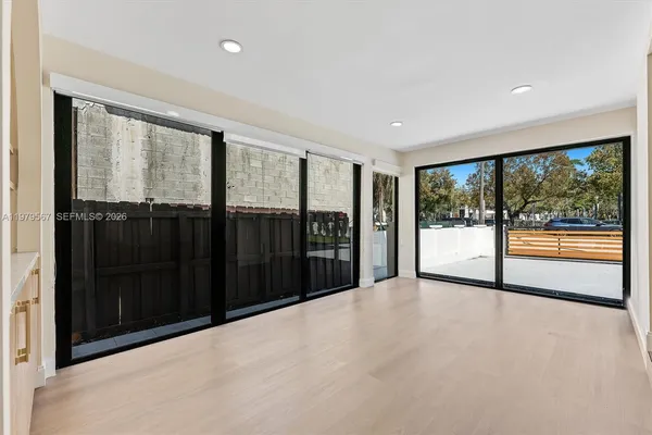 a view of an empty room with glass windows