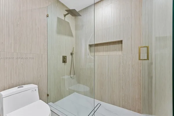 a bathroom with a toilet and a shower