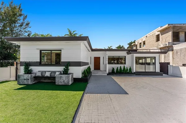 a front view of a house with a garden and yard