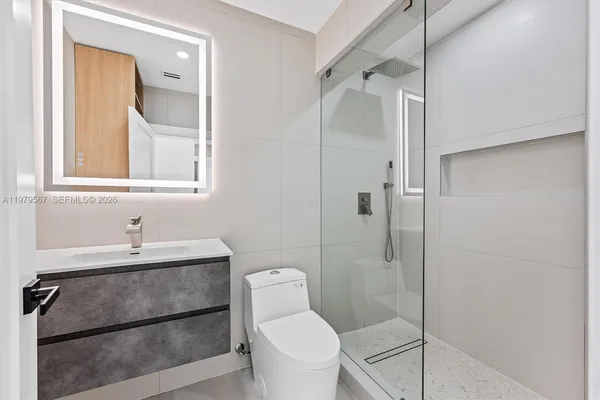 a bathroom with a sink toilet and shower