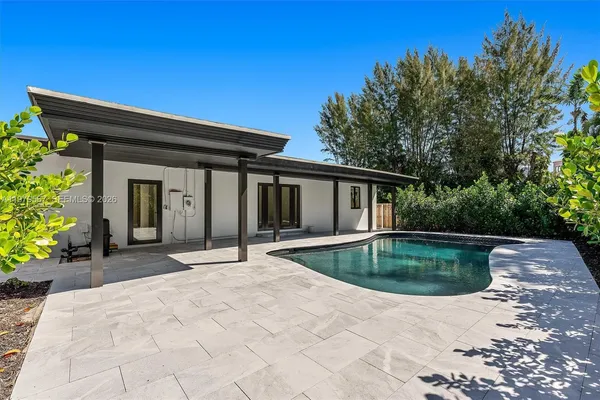 a view of pool with outdoor seating and plants