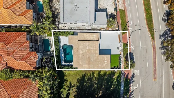 aerial view of a house with a yard and plants