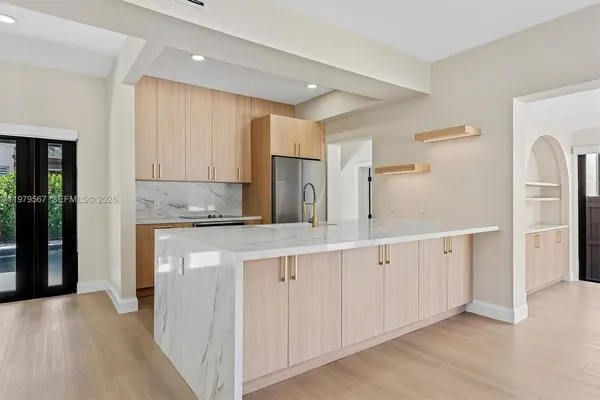 a spacious bathroom with a granite countertop sink and a mirror