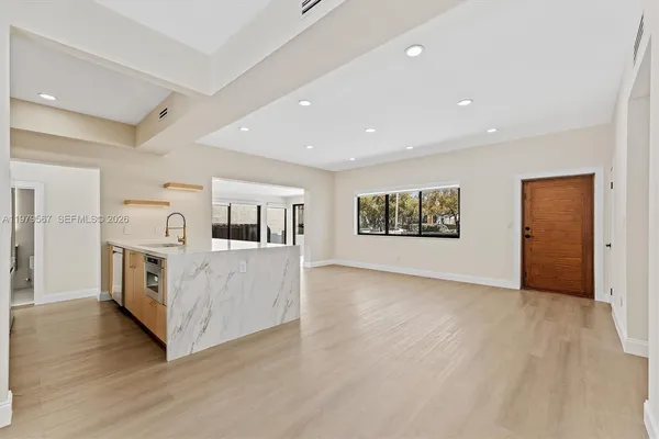 a view of living room with furniture and wooden floor
