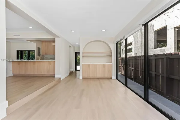 a view of an empty room with a kitchen