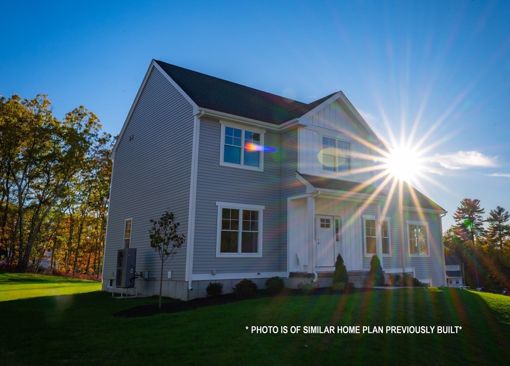 10 Mechanic Street Upton, MA 01568 - Photo 1 of 4 a front view of a house with a garden
