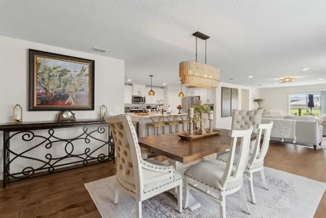 a living room with furniture a wooden floor and a chandelier