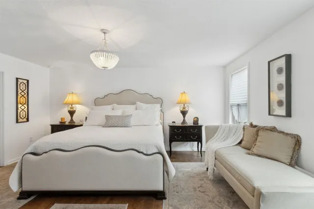 a bedroom with a bed and a table