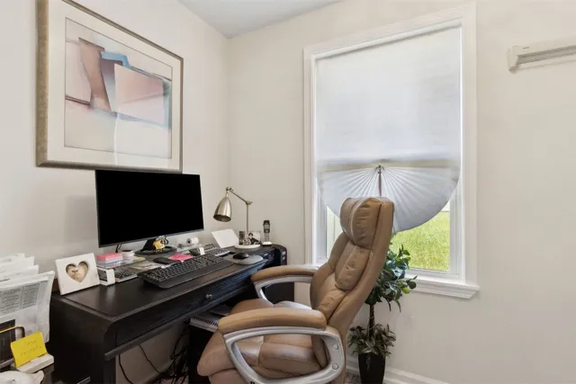 a view of a livingroom with furniture and floor to ceiling window