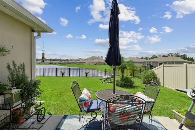 a view of a patio with table and chairs potted plants