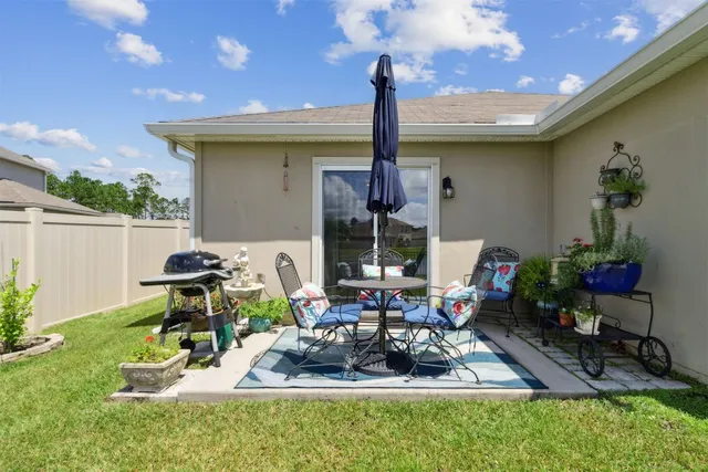 a backyard of a house with yard fountain table and chairs