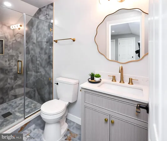 a bathroom with a sink a toilet and a mirror