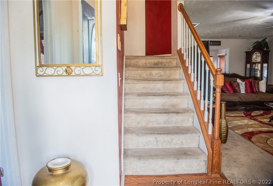 200 Lattimore Road Cameron, NC 28326 - Photo 18 of 32 a view of staircase with wooden floor and furniture