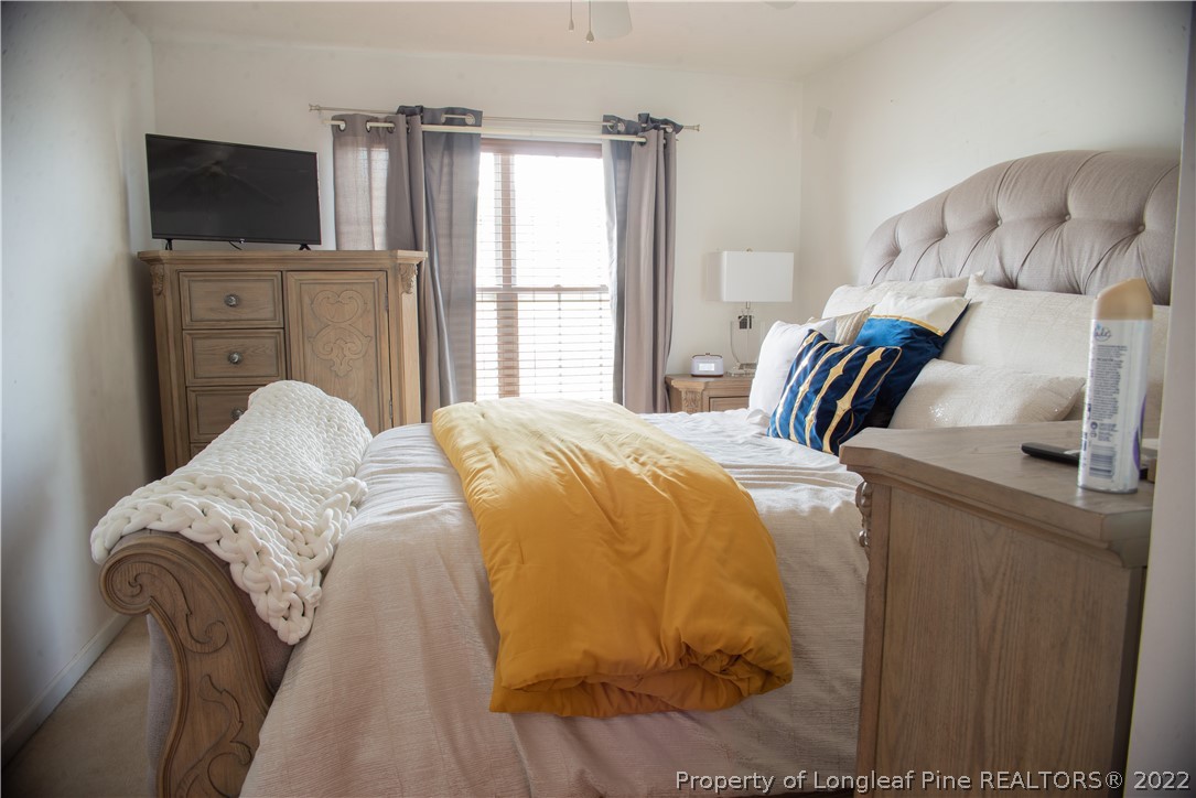 200 Lattimore Road Cameron, NC 28326 - Photo 21 of 32 a bedroom with a bed and flat screen tv