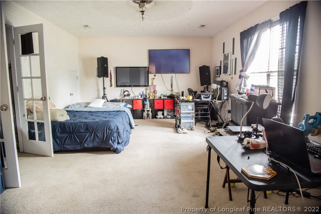 200 Lattimore Road Cameron, NC 28326 - Photo 22 of 32 a living room with furniture and a flat screen tv