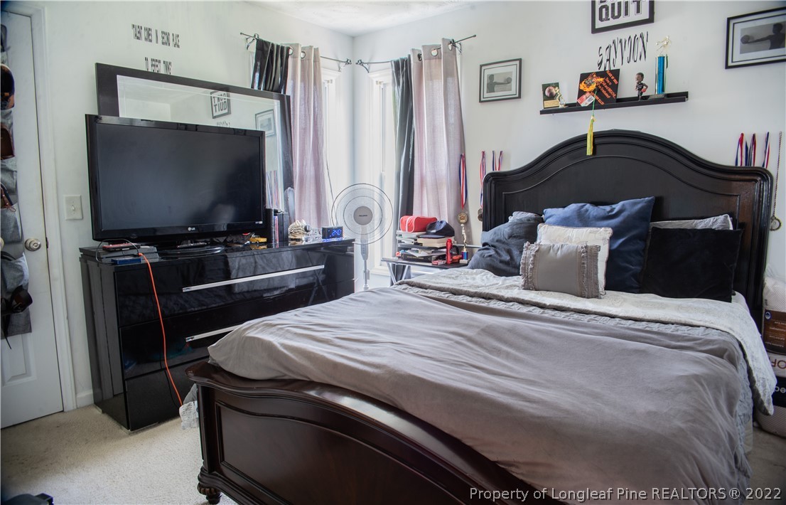 200 Lattimore Road Cameron, NC 28326 - Photo 25 of 32 a bedroom with a bed and a flat screen tv