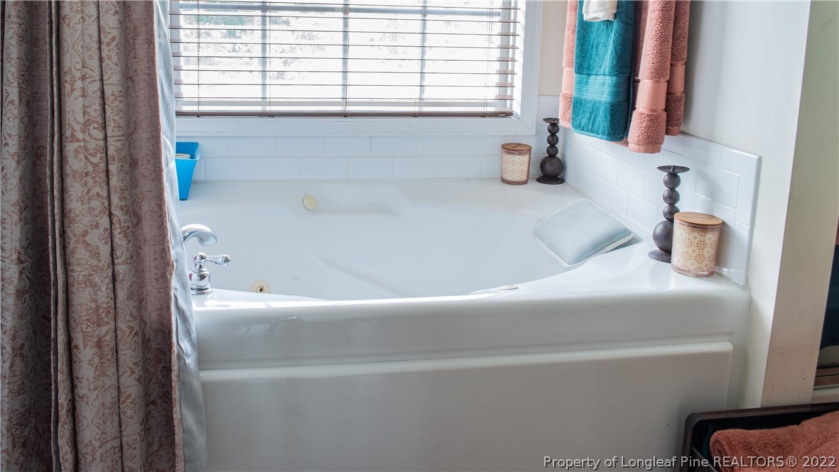 200 Lattimore Road Cameron, NC 28326 - Photo 29 of 32 a bathroom with a bathtub and a window