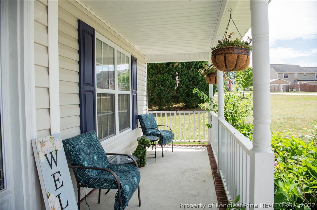 200 Lattimore Road Cameron, NC 28326 - Photo 4 of 32 a porch area with table and chairs