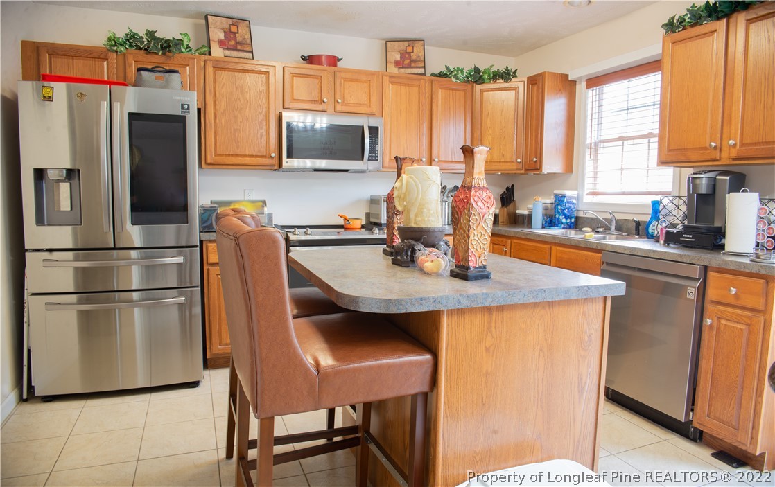 200 Lattimore Road Cameron, NC 28326 - Photo 10 of 32 a kitchen with refrigerator cabinets and a center island