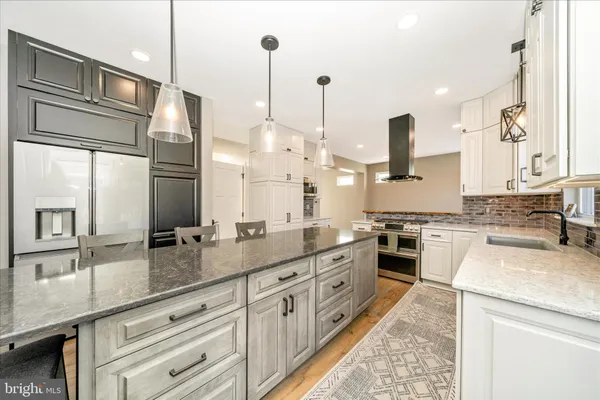 a kitchen with white cabinets and appliances