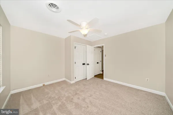a view of a house with a yard and a fire pit