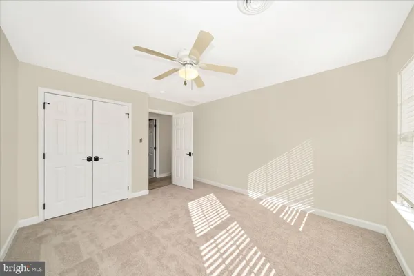 a view of a pathway of a house with a yard