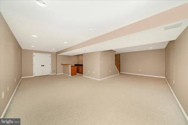 a view of a house with a floor to ceiling windows and a basket ball poll