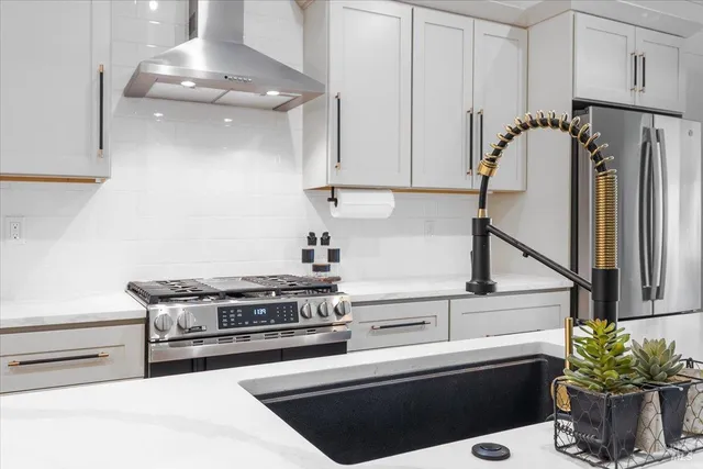a kitchen with stainless steel appliances a stove and a refrigerator