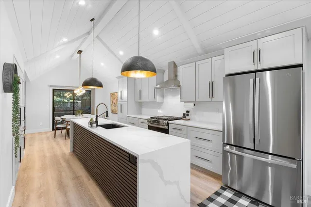 a kitchen with a sink stainless steel appliances and cabinets