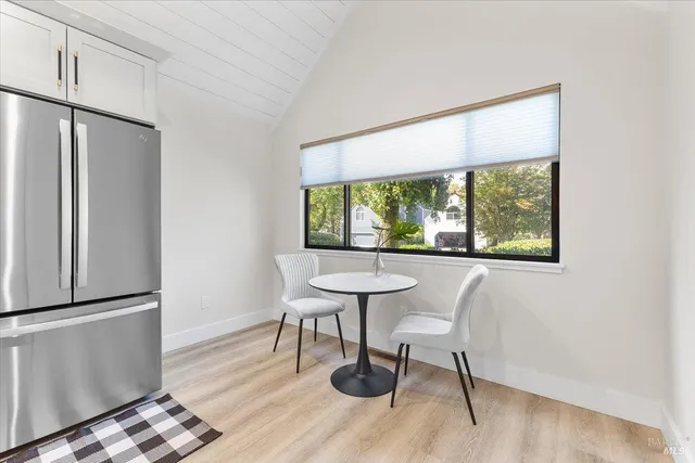 a view of a workspace with furniture and a window