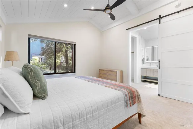 a bedroom with a large bed and a window