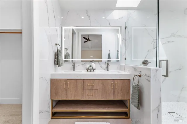 a bathroom with a sink double vanity and a mirror