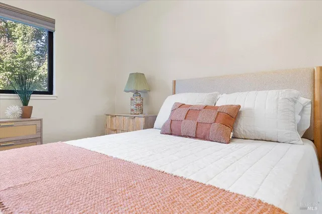 a bedroom with a bed and a lamp