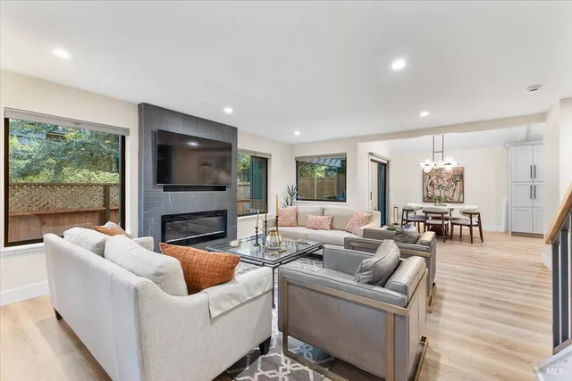 a living room with fireplace furniture and a flat screen tv