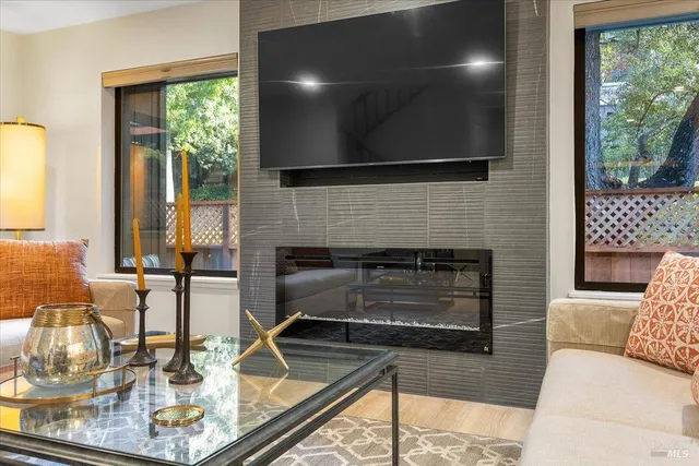 a living room with fireplace furniture and a flat screen tv