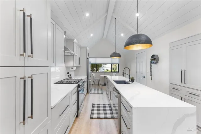 a kitchen with stainless steel appliances a stove sink and refrigerator
