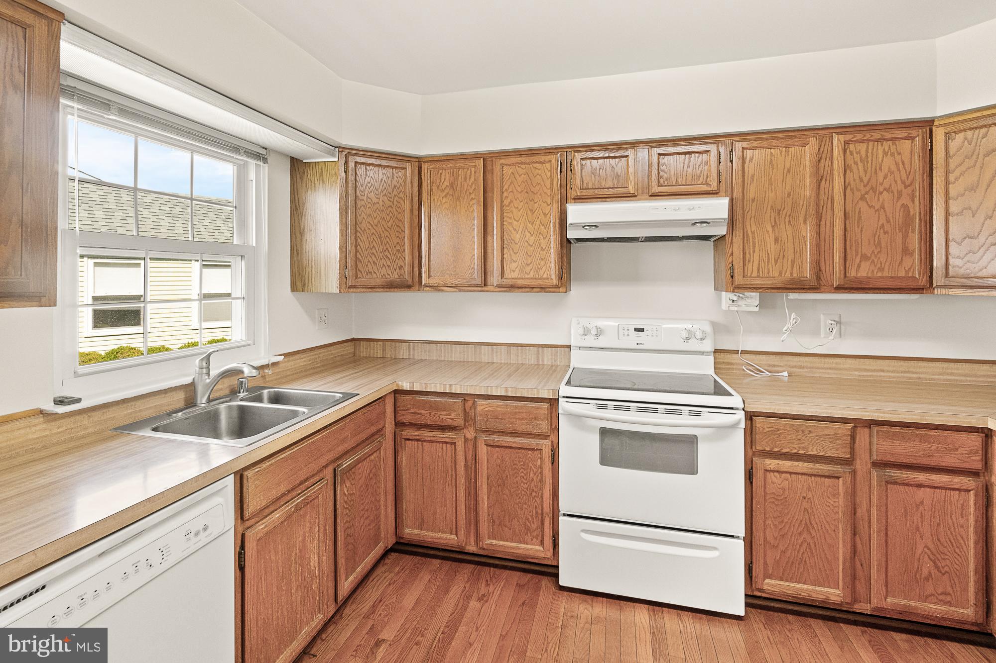7050 Catalpa Road Frederick, MD 21703 - Photo 22 of 78 a kitchen with a sink cabinets appliances and a window