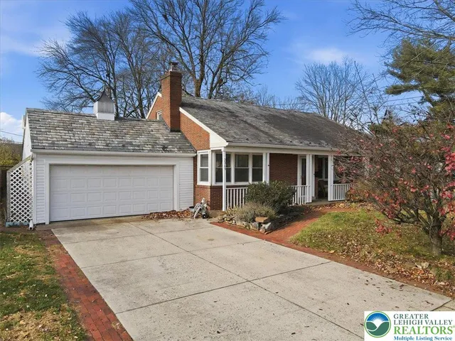 a view of a house with a yard and potted plants