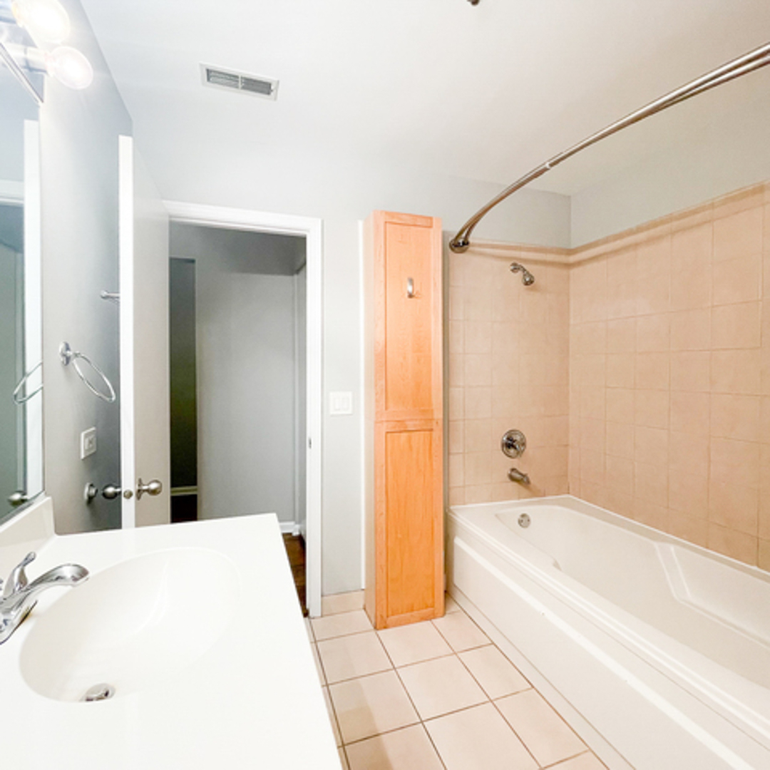 520 West Huron Street, Unit 116 Chicago, IL 60654 - Photo 18 of 28 a bathroom with a bathtub and a shower