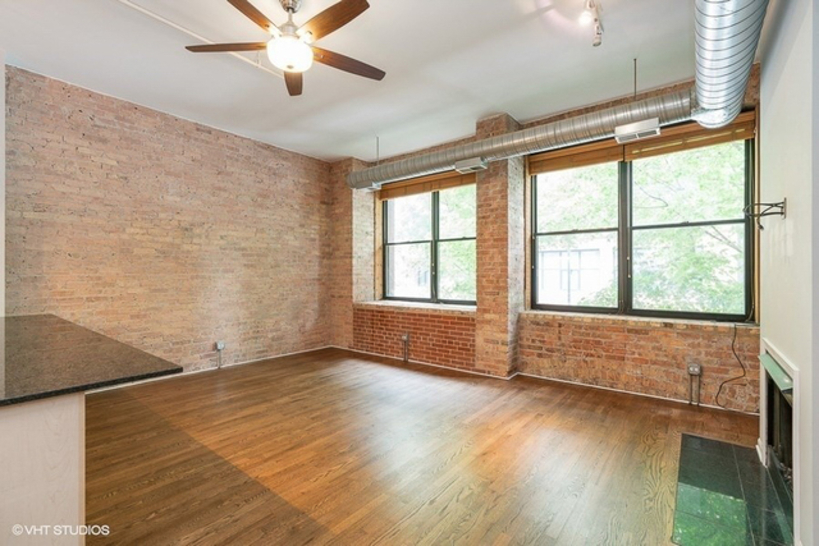 520 West Huron Street, Unit 116 Chicago, IL 60654 - Photo 7 of 28 an empty room with wooden floor and windows