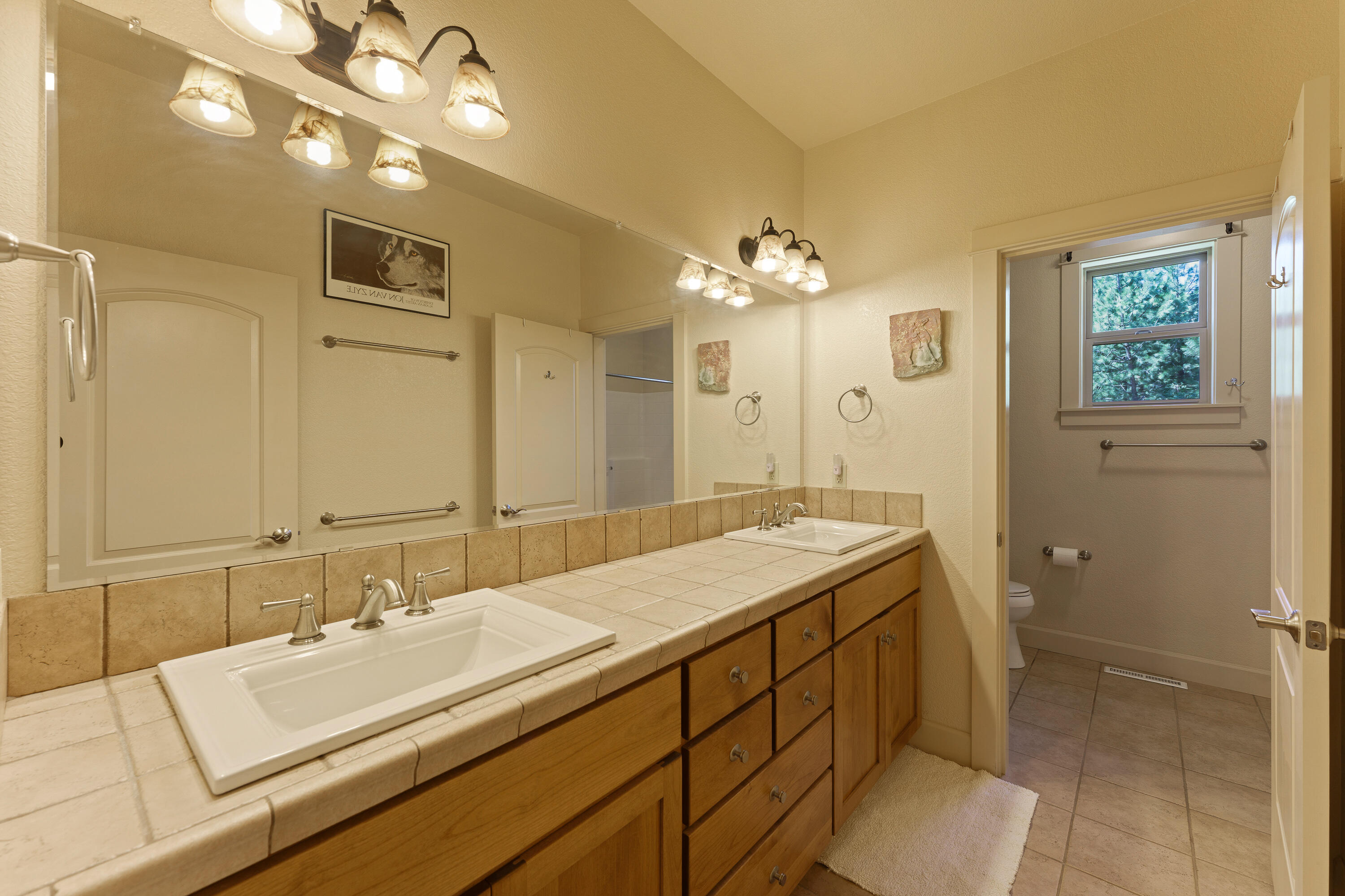 19236 Kiowa Road Bend, OR 97702 - Photo 28 of 52 a en suite bathroom with a double vanity sink and a mirror