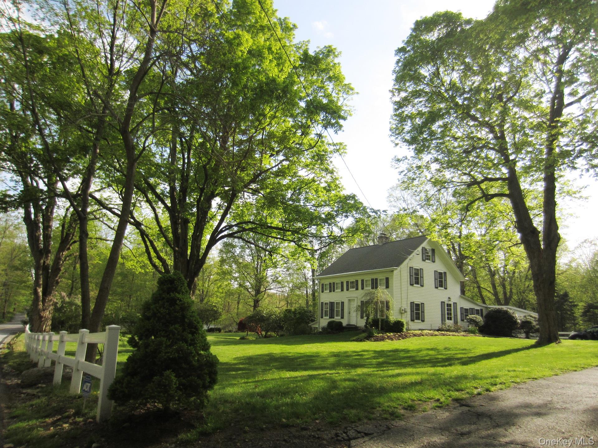 521 Barrett Hill Road Mahopac, NY 10541 - Photo 1 of 35 a view of a big house with a big yard and large trees