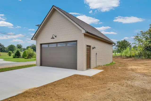 a view of a house with a yard and garage