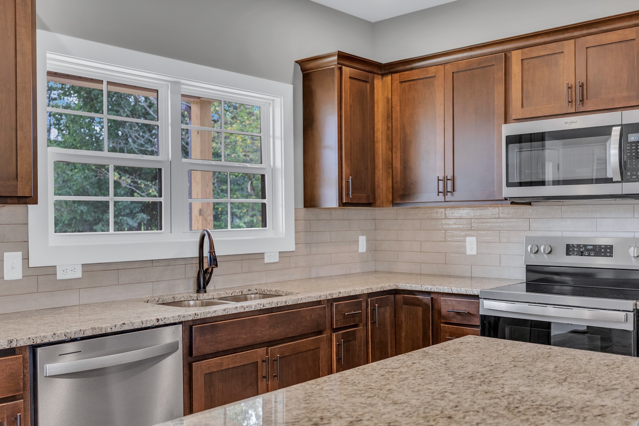 270 Locust Grove Road Cookeville, TN 38501 - Photo 4 of 34 a kitchen with stainless steel appliances granite countertop a sink a stove and cabinets