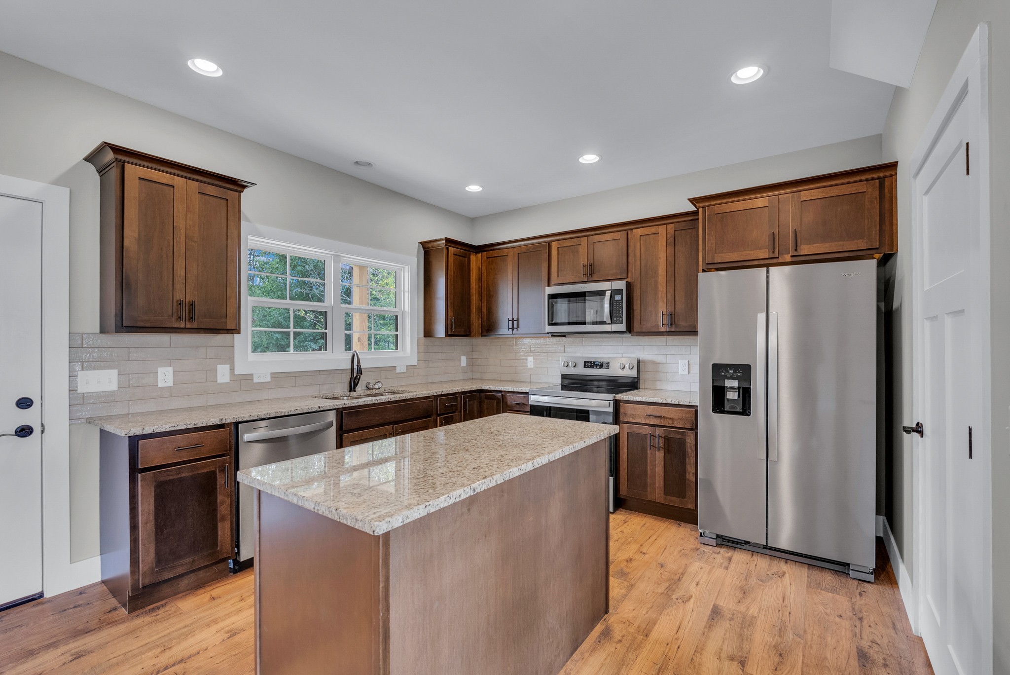 270 Locust Grove Road Cookeville, TN 38501 - Photo 5 of 34 a kitchen with stainless steel appliances granite countertop a refrigerator a sink dishwasher a stove top oven a refrigerator with wooden floor and cabinets